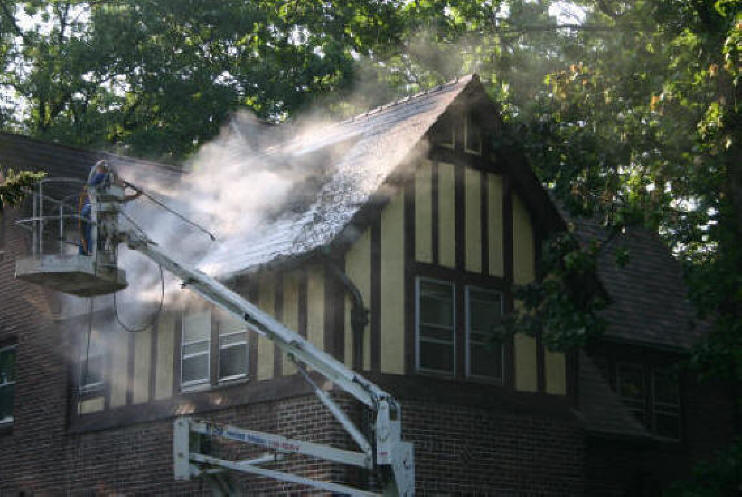 Steam cleaning asbestos roofing.