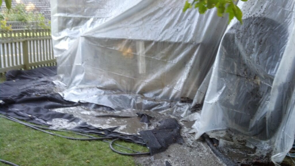 Building tarped off to catch dirt from asbestos roof.